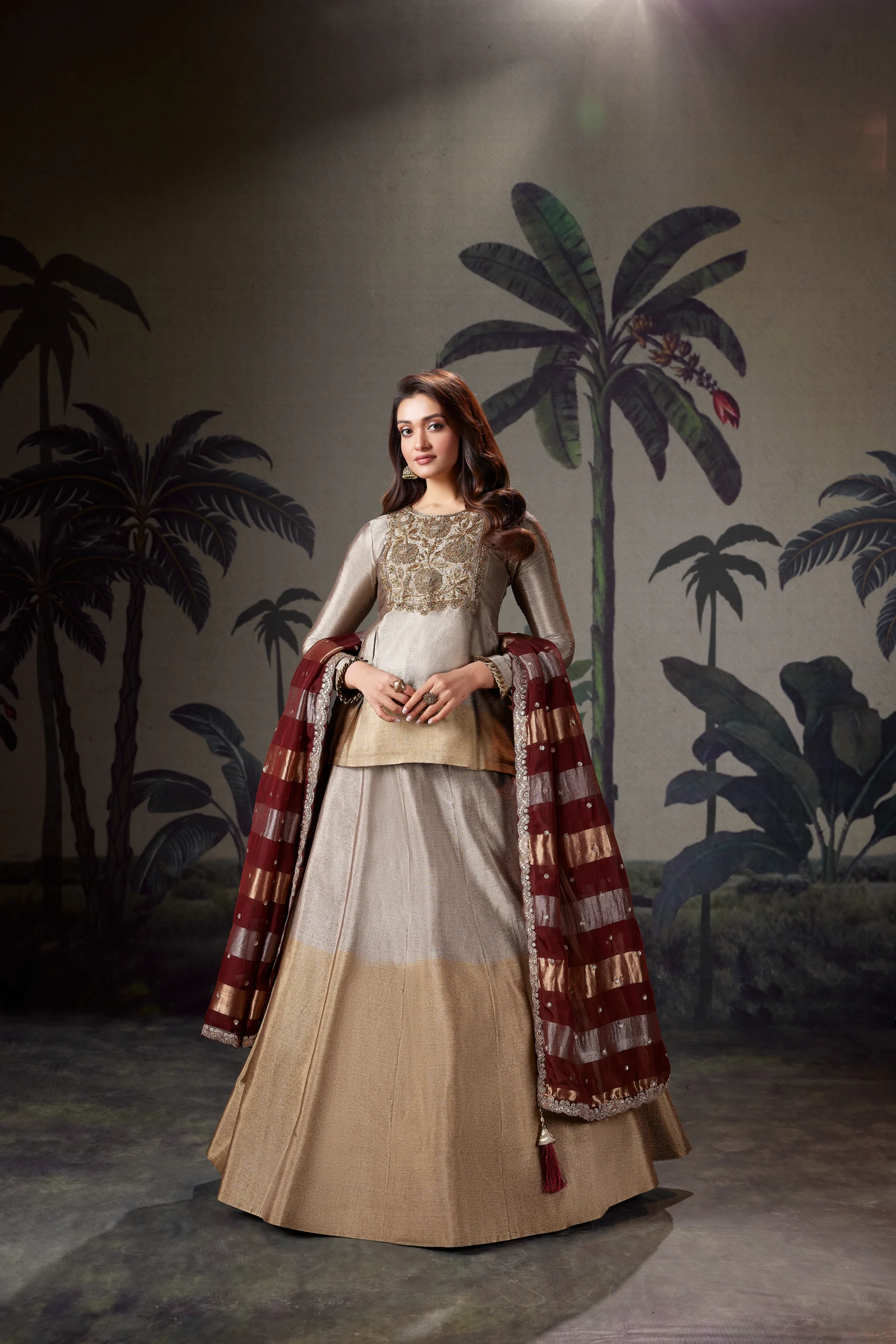 Model in an ivory RP Dalmia lehenga with a maroon checked dupatta