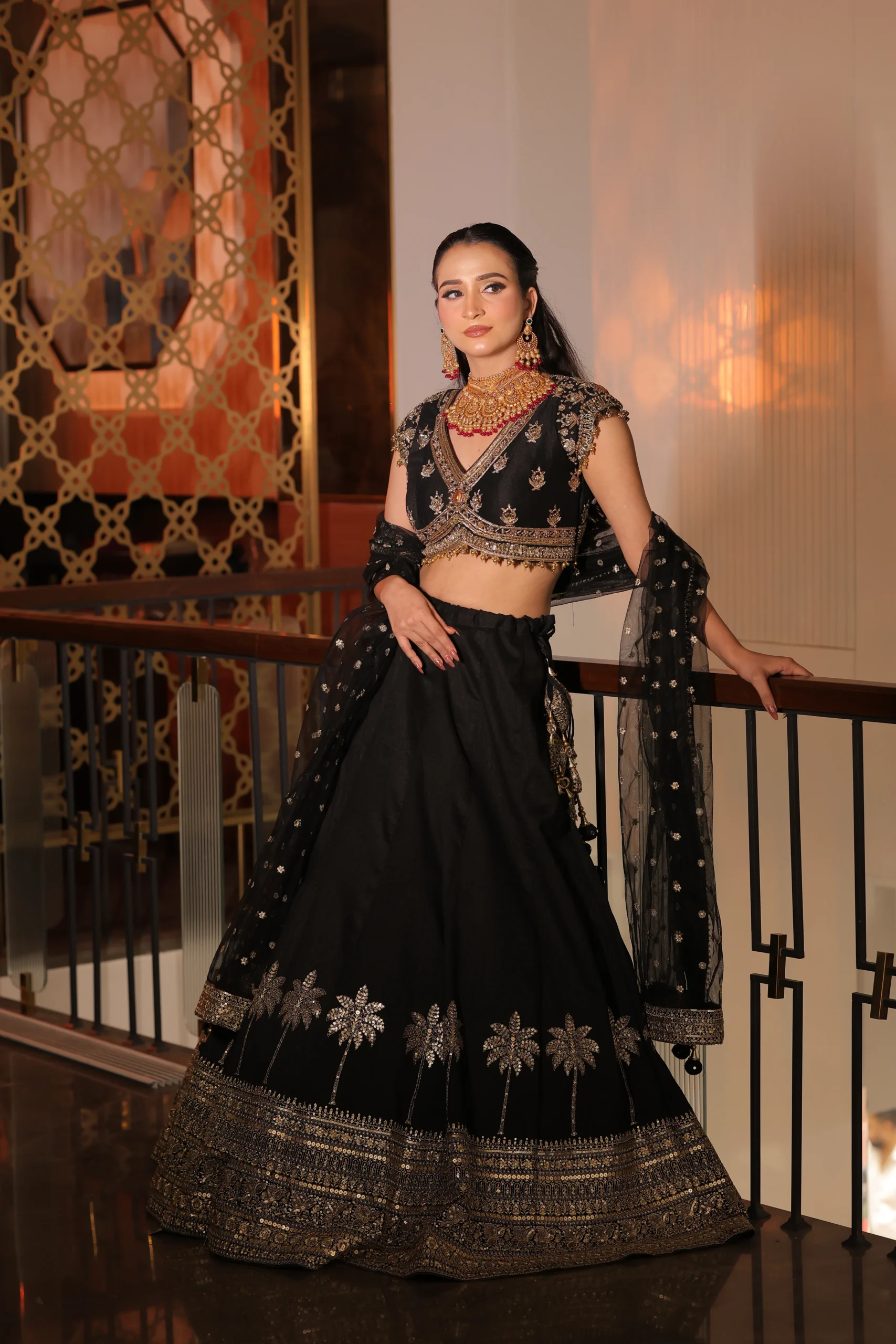 Model in a black and gold RP Dalmia lehenga